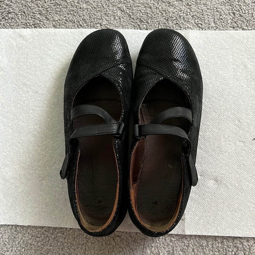 Gently worn black slip on ladies shoes.  Velcro cross closure